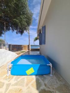 a blue swimming pool sitting next to a building at Villa Elia Perigiali Lefkada in Nydri