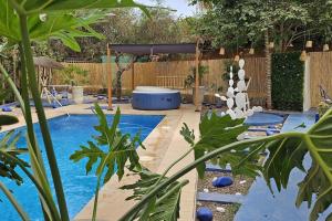 a swimming pool in a backyard with a fence at La kasbah bleue in Marrakesh
