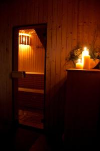 a mirror with a lit candle in a room at Privat Jasmin in Mengusovce