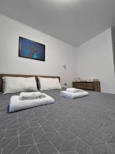 a large bed with two pillows on top of it at Studio Saturn in Saturn