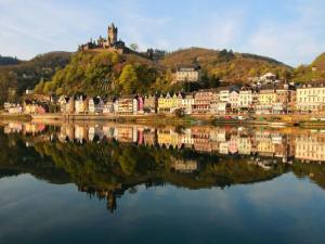 a town on a hill next to a body of water at Winkelchen Comfortable holiday residence in Cochem