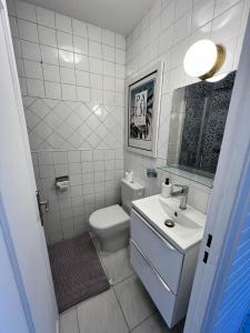 a white bathroom with a toilet and a sink at #T03 DUCAL MARINA BAIE DES ANGES avec Terrasse in Villeneuve-Loubet