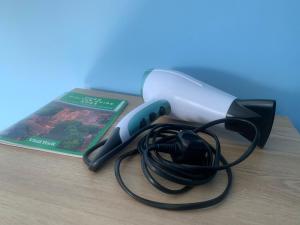 a pair of scissors and a book on a table at Top of Family Occupied House Double Room with Free Parking in York in York