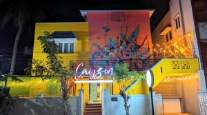 a building with graffiti on the side of it at Cayzen in Chennai