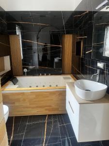 a bathroom with a tub and a sink at AG SUITE TRAPANI in Trapani +27 photos
