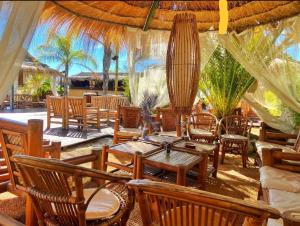 a restaurant with wooden tables and chairs and a lot ofitures at DONNA FILOMENA Residence in Marina di Camerota