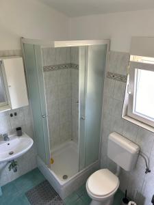 a bathroom with a shower and a toilet and a sink at Apartments Anka Brala in Posedarje +21 photos