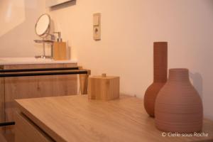 two vases sitting on top of a wooden counter at Cielle sous Roche in La-Roche-en-Ardenne +19 photos