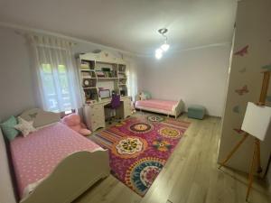 a childs bedroom with a bed and a rug at Luxury House in Shkodër
