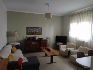 a living room with a couch and a table at 3 STEPS in Alexandroupoli