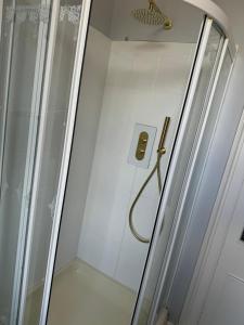 a shower in a bathroom with a glass door at 4 bed Harbour House in Wick