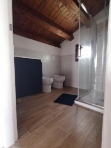 a bathroom with two toilets and a glass shower at Ca' Libellula Casa Vacanza in Avola +33 photos
