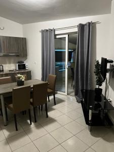 a kitchen and dining room with a table and chairs at Amfora in Bibinje