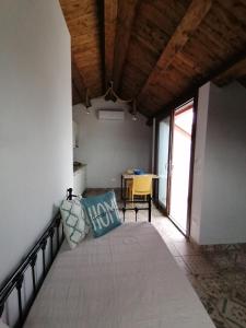 a room with a bed with pillows on it at Ca' Libellula Casa Vacanza in Avola