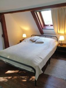 a large bed in a room with a window at Altes Otto Haus in Stamsried