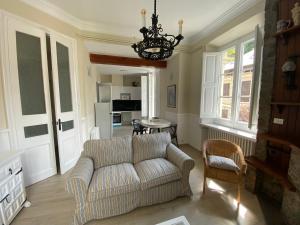 a living room with a couch and a chandelier at Principal Casa Pomar in Camprodon