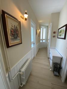 a hallway with white walls and a picture on the wall at Principal Casa Pomar in Camprodon