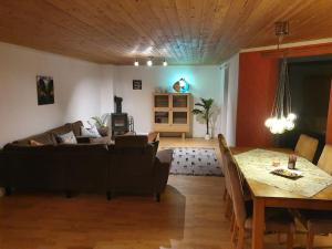 a living room with a couch and a table at Kellergeschosswohnung mit Aussicht und Terasse in Strand
