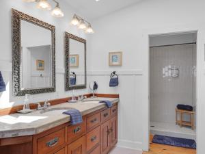 a bathroom with two sinks and two mirrors at Pacific Northwest Beach House 5G EV Charger Dog in Gearhart +92 photos