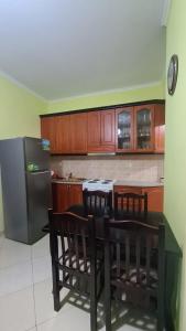 a kitchen with a table and a refrigerator at Bega Apartment in Sarandë