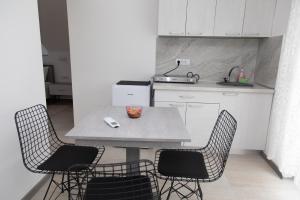 a kitchen with a table and chairs in a kitchen at VILA Milovanović in Mataruška Banja