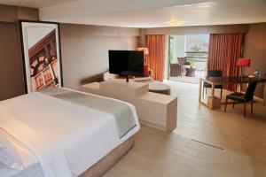 a hotel room with a bed and a desk and a television at Casa Andina Premium Golf Los Incas in Lima +113 photos