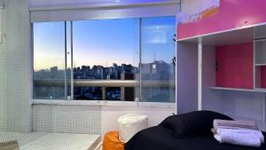 圣保罗Só Mulheres Cobertura Duplex Alto Padrão Shows Ginásio Parque Ibirapuera Jardins Av Paulista Paraíso Vl Mariana的卧室设有大窗户,享有城市美景 更多37张照片