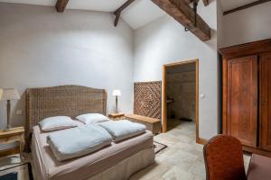 a bedroom with a bed and a desk and a chair at Chateau de la Vieille Chapelle in Lugon et l’Ile du Carney