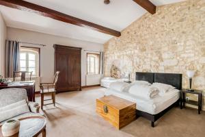a living room with a bed and a couch at Chateau de la Vieille Chapelle in Lugon et l’Ile du Carney