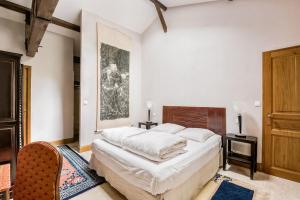a bedroom with a large bed in a room at Chateau de la Vieille Chapelle in Lugon et l’Ile du Carney