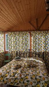 a bedroom with a bed with a colorful comforter at cottage Merisi inn in Gundauri