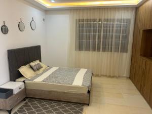 a bedroom with a large bed and a window at Grande Villa Familiale Route Du Phare in Djerba +27 photos