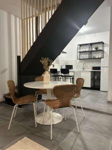 a dining room with a white table and chairs at Maison moderne au cœur de Caudry in Caudry