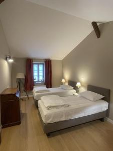 a bedroom with three beds and a window at Chateau de la Vieille Chapelle in Lugon et l’Ile du Carney