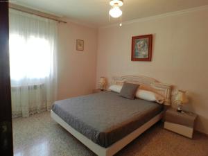 a bedroom with a large bed and a window at Chalet con piscina Umut Homes in Alicante +34 photos