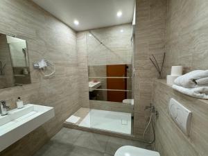 a bathroom with a shower and a sink and a toilet at Hotel Panorama in Grasse