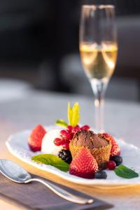a plate of food and a glass of wine at Hotel Boutique Ses Pitreras in San Antonio Bay