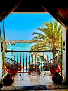 a balcony with chairs and a view of the ocean at Unforgettable views of Marina Agadir in Agadir