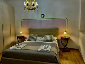 a bedroom with a large bed with two tables at Alloggio Turistico San Valentino 5,8 in Poggio Mirteto