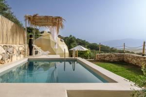a swimming pool in a backyard with a tent at Gogna luxury domes in Gonia