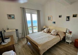 a bedroom with a bed and a large window at Apartments Lusi in Brela