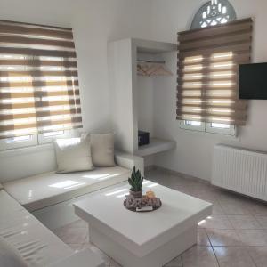a living room with a couch and a table at Il Margio Studio in Tinos Town
