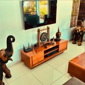 a wooden entertainment center in a room with a mirror at Samui Sunset 22G in Choeng Mon Beach