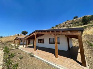 a house in the middle of a hill at MonteSoprano Agriturismo - Resort - Spa - Gym -Camping - Suite in Capizzi