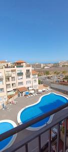 a view of a swimming pool from a balcony at Chilly Apartment - Sunny rooftop terrace with ocean view in Callao Salvaje