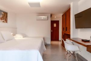 TV a/nebo společenská místnost v ubytování Hotel Paraiso do Morro