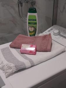 a pink towel and a bottle of soap on a counter at Obilex in Podgorica