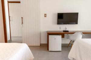 TV a/nebo společenská místnost v ubytování Hotel Paraiso do Morro