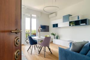 a kitchen and living room with a table and chairs at Milan Comfort Apartment in Milan