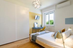a bedroom with a bed and a desk at Milan Comfort Apartment in Milan